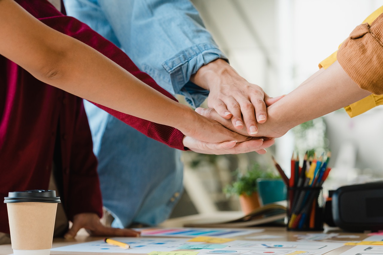 asian-businessmen-businesswomen-meeting-brainstorming-putting-hands-up-new-startup-giving-strength-motivation-working-together-modern-creative-office-coworker-teamwork-concept.jpg
